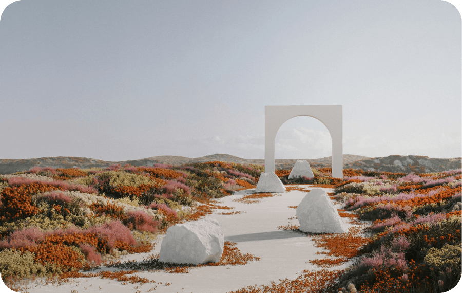 Pathway with large white rocks leading through colorful low vegetation to a white stone arch under a clear sky.